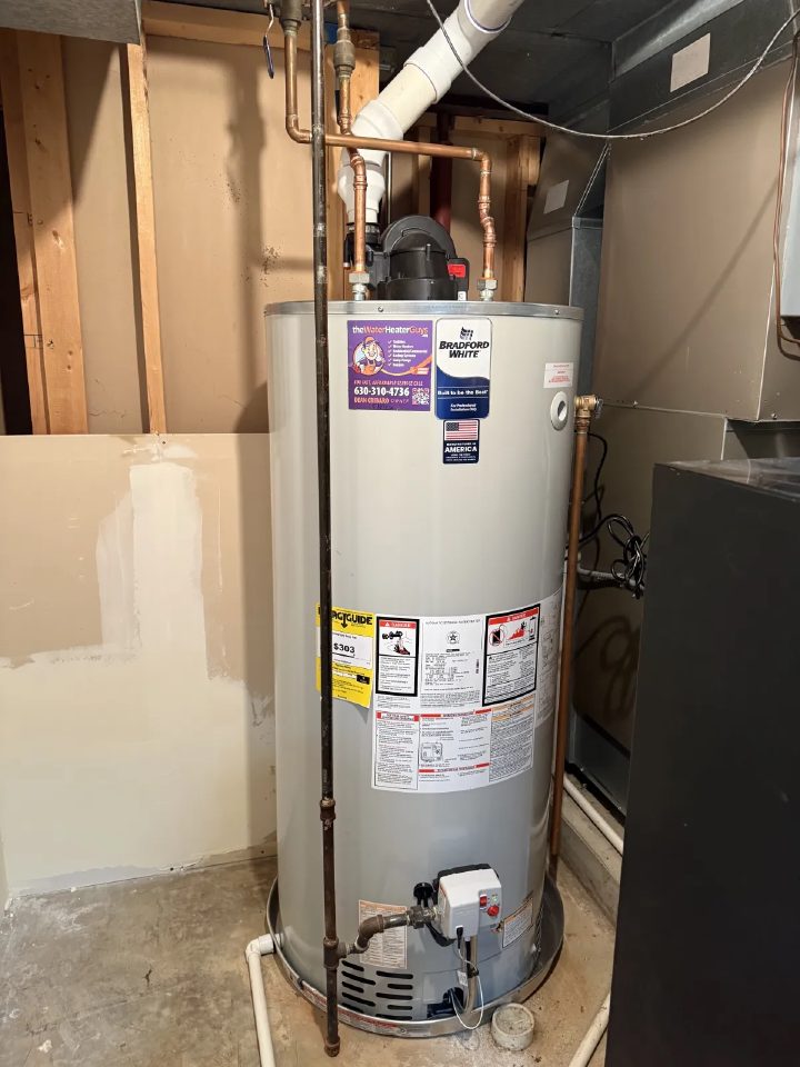 Bradford White power-vent tank water heater installed in an Elgin basement with copper supply lines and PVC exhaust venting