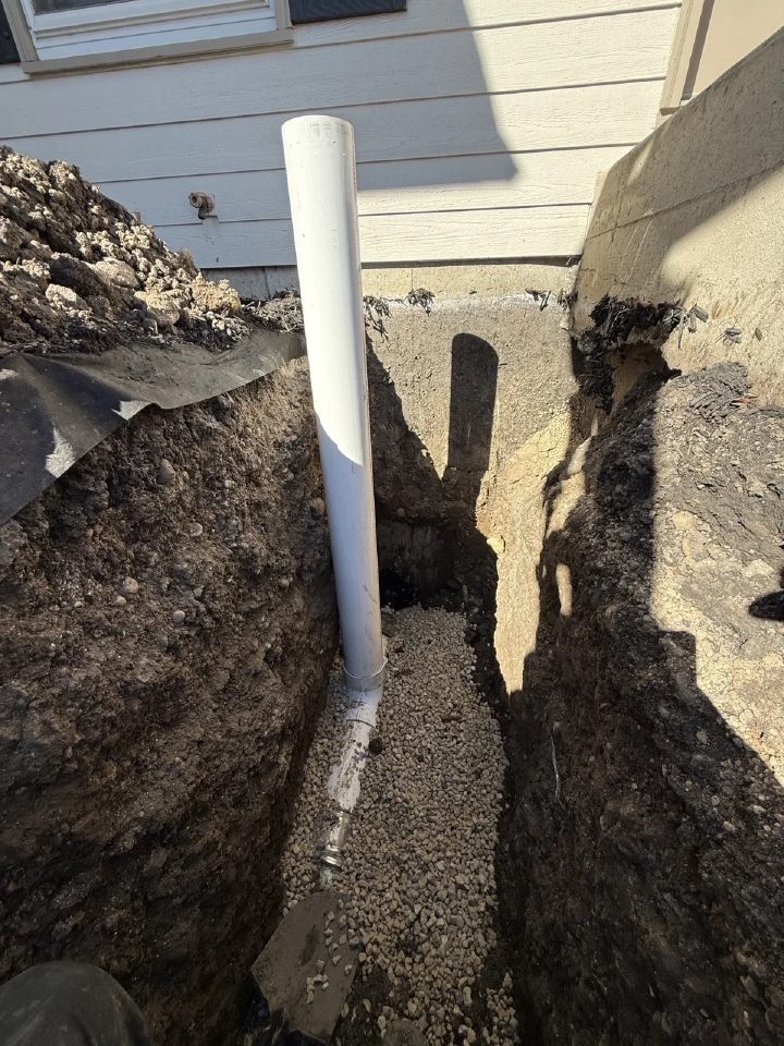 Outside sewer cleanout standpipe installed in a trench at the foundation of a St. Charles home